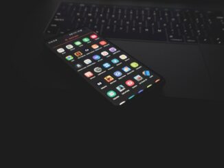 Person holding a smartphone for mobile communication. Photo by Azamat E on Unsplash.