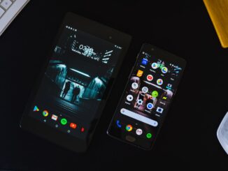 Smartphone and laptop used together for digital services. Photo by The Average Tech Guy on Unsplash.
