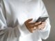 Woman holding a smartphone while using mobile services. Photo by Kelli McClintock on Unsplash.