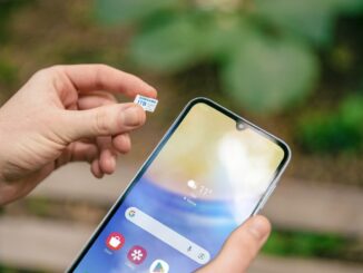 Person holding a smartphone with a mobile service screen. Photo by Samsung Memory on Unsplash.