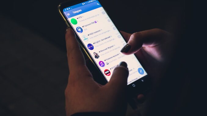 Smartphone showing a text messaging interface. Photo by Christian Wiediger on Unsplash.